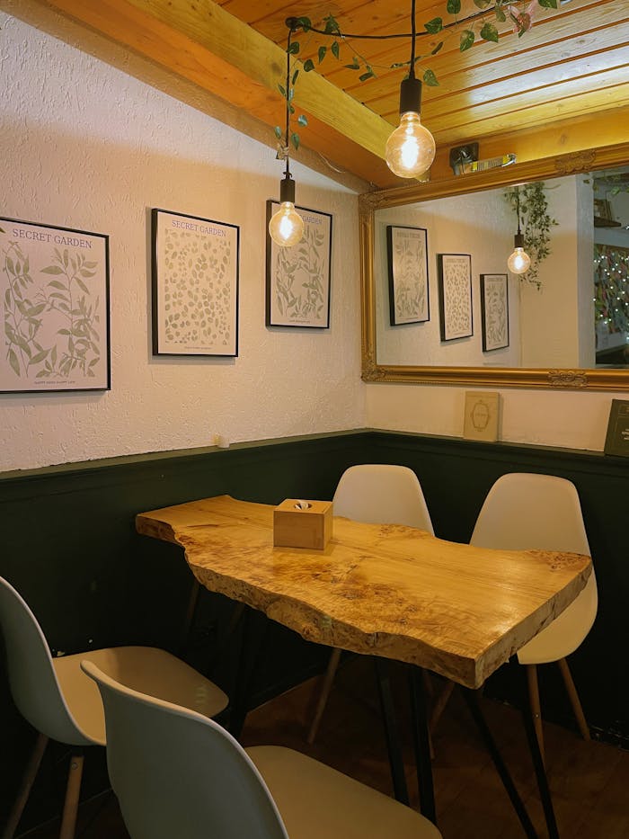 Warm cafe setting featuring a rustic wooden table and stylish decor.