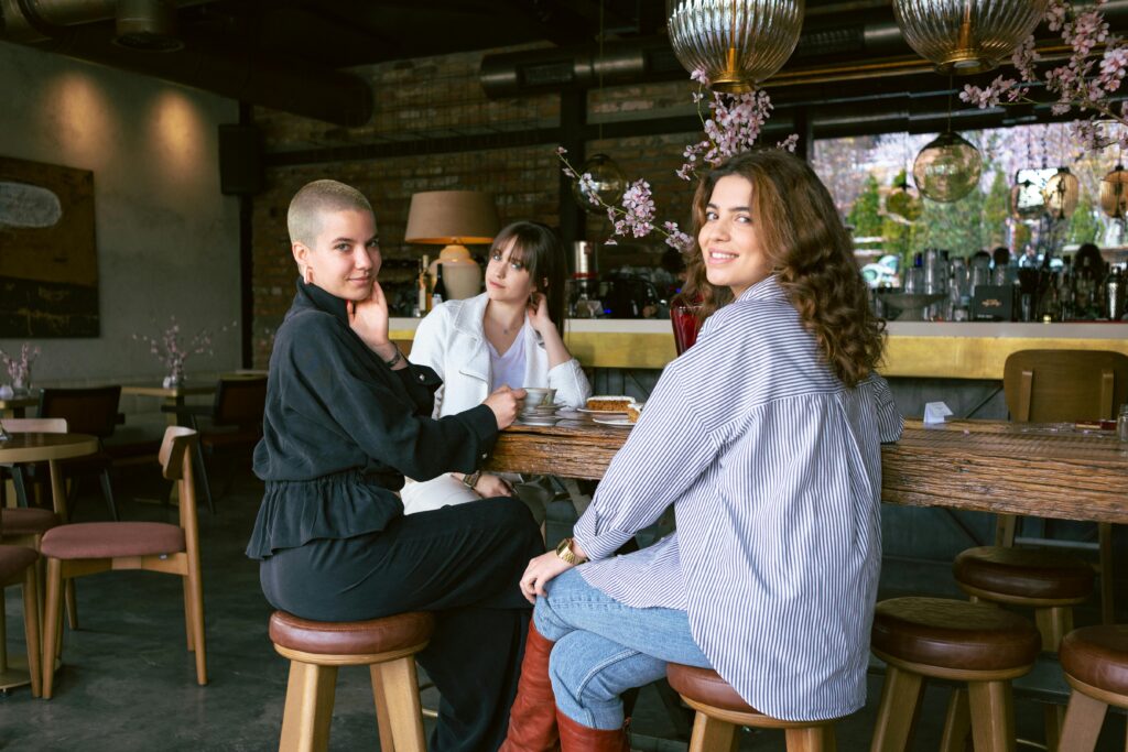 pexels-photo-15984006-15984006 Three stylish women relaxing and socializing at a chic café, enjoying their time together.