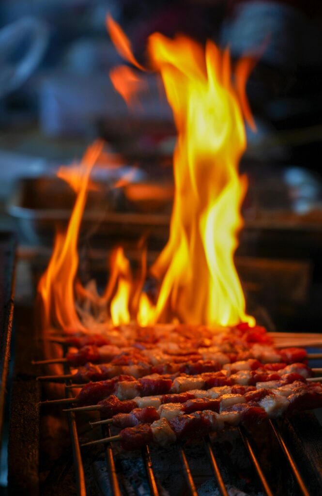 pexels-photo-34613803-34613803 Juicy meat skewers being grilled over an open flame, perfect for BBQ lovers.